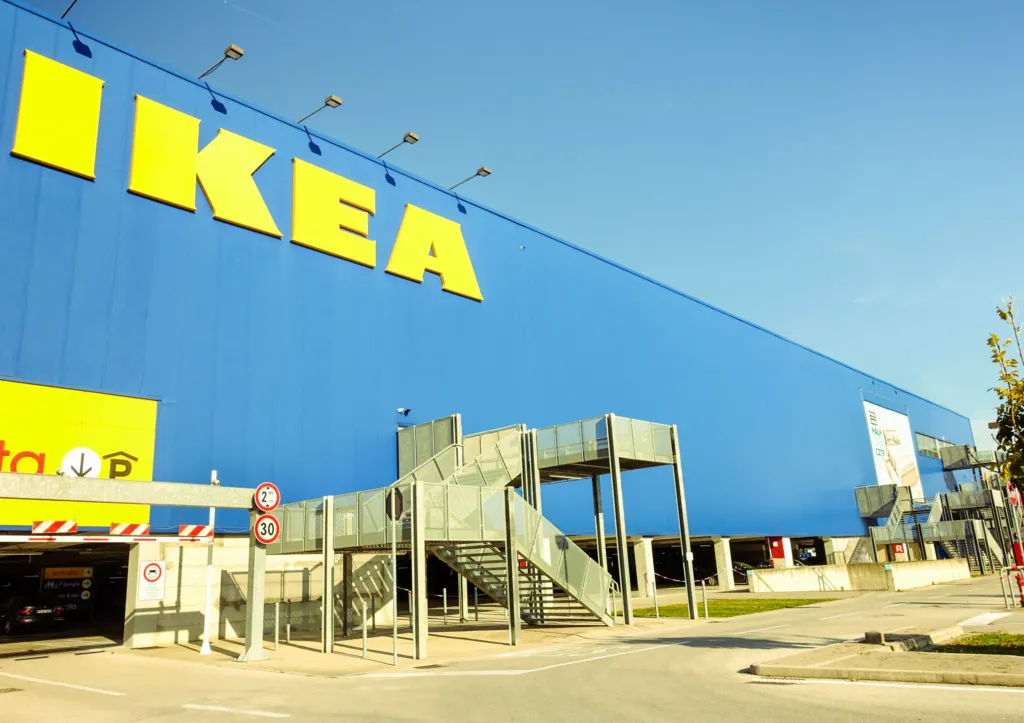 Exterior view of a large blue and yellow IKEA store representing the cognitive bias known as the IKEA effect